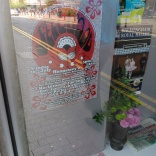 poster and flyers in a local shop window